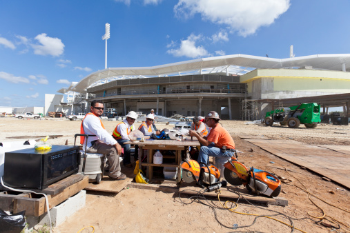 Ft. Myers, Florida, United States - November 2, 2011:  Construction workers take their lunch break on the grounds of the new Boston Red Sox Stadium that is being built for spring training.