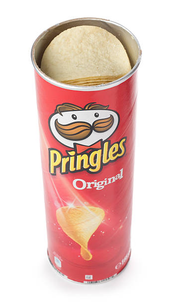 Tube of Pringles original potato chips isolated on white background St Ives, England - October 20, 2011: A tube of Pringles original potato chips isolated on white background. Pringles are produced by Procter & Gamble and sold in more than 140 countries. Tube of Pringles stock pictures, royalty-free photos & images
