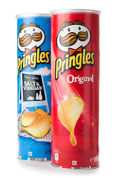 Tubes of Pringles original and salt & vinegar potato chips St Ives, England - October 20, 2011: Tubes of Pringles original and salt & vinegar flavor potato chips isolated on white background. Pringles are produced by Procter & Gamble and sold in more than 140 countries. Tube of Pringles stock pictures, royalty-free photos & images