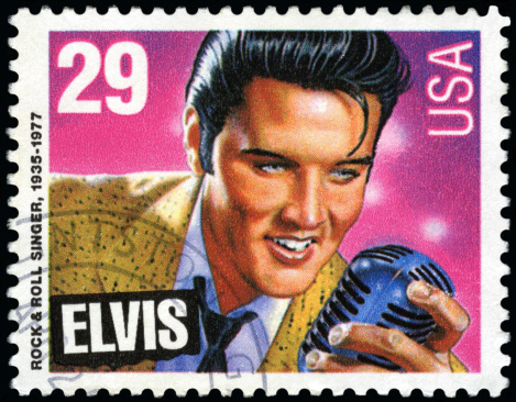 Seattle, Washington, USA - January 03, 2012: A 1993 USA postage stamp with an illustration of Elvis Presley holding a microphone. The stamp illustraton of \