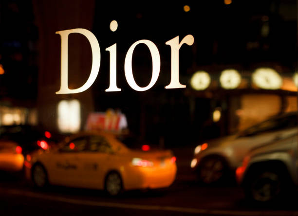 New York, New York, USA - October 22, 2011: The reflective Dior sign on the Christian Dior boutique on 57th street In Manhattan. The reflection of nighttime street traffic can be seen below the Dior logo.