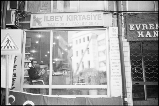 Istanbul, Turkey - November, 2009: A man sits inside Ilbey Kirtasiye, a stationary store in Istanbul.