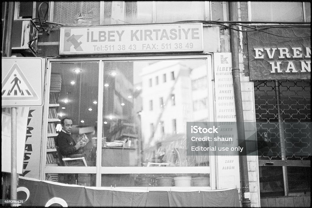 Stationary Istanbul, Turkey - November, 2009: A man sits inside Ilbey Kirtasiye, a stationary store in Istanbul. Adult Stock Photo