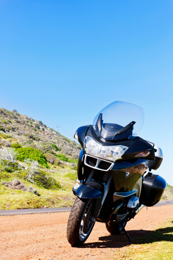 Cape Town, South Africa - 30 January, 2011: Front-on view of a BMW R1200RT touring motorbike, the 2006 model,  parked on a deserted mountain road on a clear, sunny day. This model is currently the flagship of BMW's 