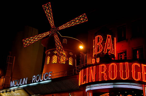 Moulin Rouge Paris, France - November 26, 2011: Moulin Rouge entrance in Paris. The Moulin Rouge is world famous for it's burlesque shows and has even featured in it's own movie. place pigalle stock pictures, royalty-free photos & images