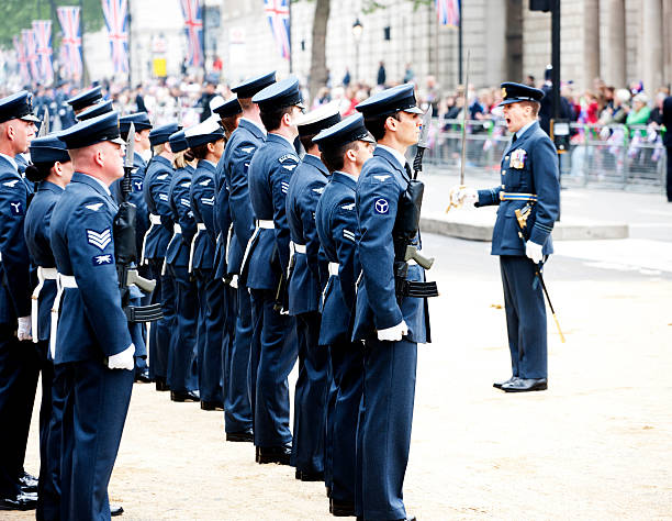 The Royal Airforce London, UK - April 29, 2011:A number of Royal Airforce men and women stand in formal array on Whitehall, outside Horse Guards.  Union Jack flags decorate London's streets to celebrate the wedding of Prince William to Catherine Middleton. Crowds of wellwishers are visible in the background. raf stock pictures, royalty-free photos & images