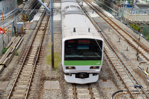Tokyo, Japan - May 30, 2011 : Yamanote Line train past the Ebisu District in Tokyo, Japan. This train is going to Tokyo Station and Shinagawa Station. Yamanote Line is one of Tokyo\'s busiest lines.