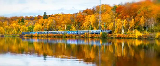 Photo of Swedish train in autumn landscape