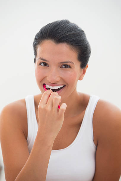 istock Young Woman Brushing Her Teeth 459401719