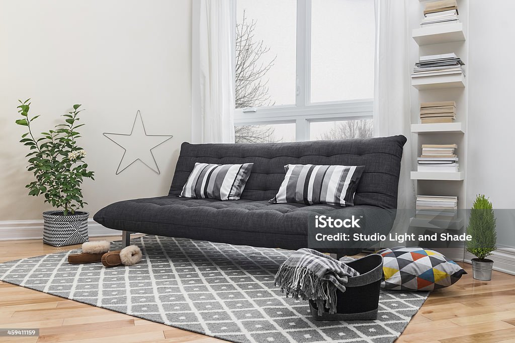 Spacious living room with modern decor Spacious living room with gray sofa and modern decor. Futon Stock Photo