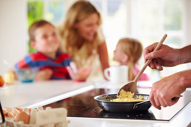 istock Father Preparing Family Breakfast In Kitchen 459425809