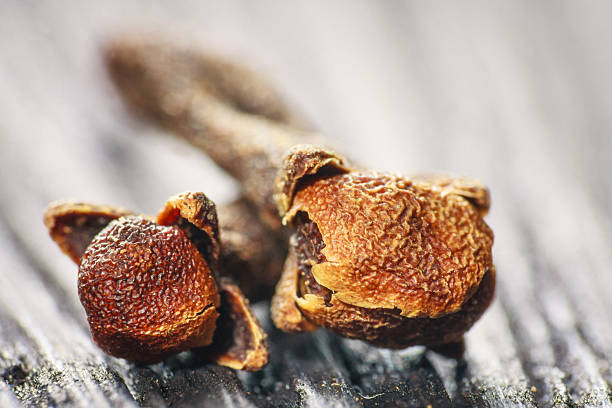 istock pile cloves on wood background 459427271