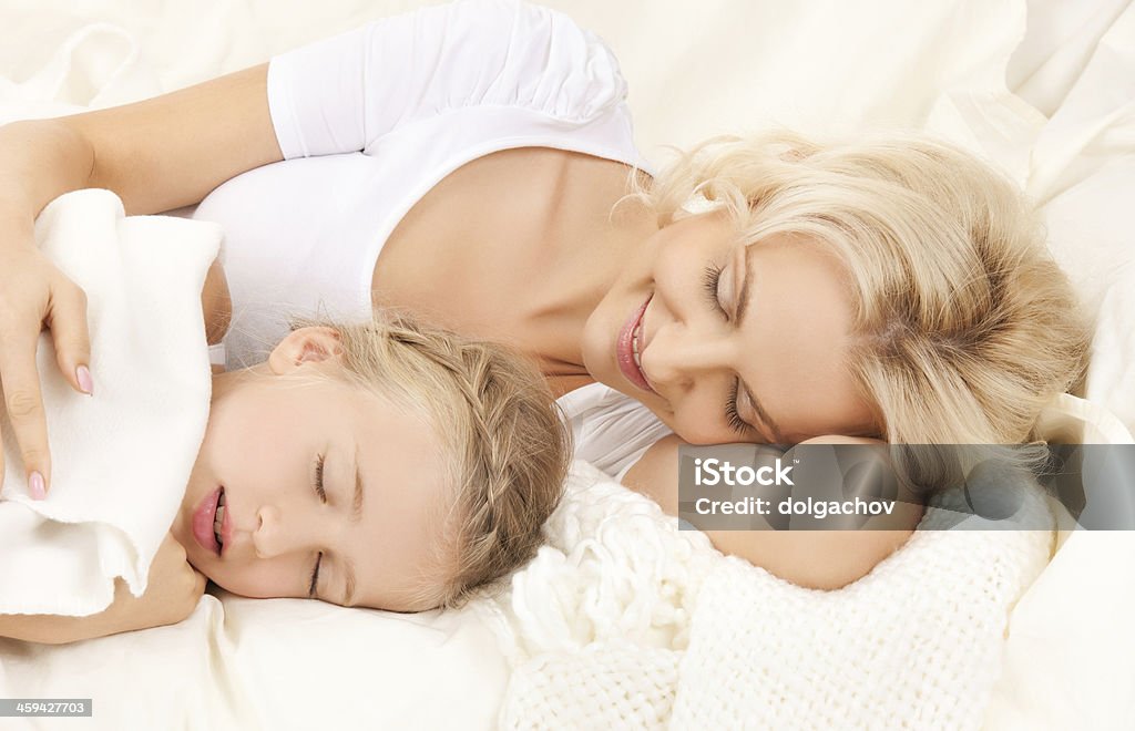 mother and child sleeping people, family and rest concept - happy mother and child sleeping Bed - Furniture Stock Photo
