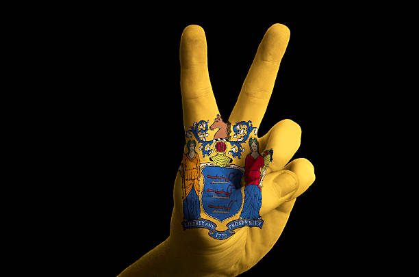 new jersey us state flag two finger up gesture Hand with two finger up gesture in colored new jersey state flag as symbol of winning, victorious, excellent, - for tourism and touristic advertising, positive political, cultural, social management of country jerseyan stock pictures, royalty-free photos & images