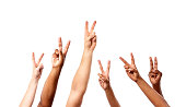 Six hands make Peace or V for Victory signal