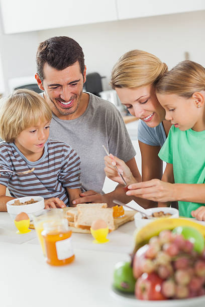 istock Mother giving breakfast to her daughter 459430899