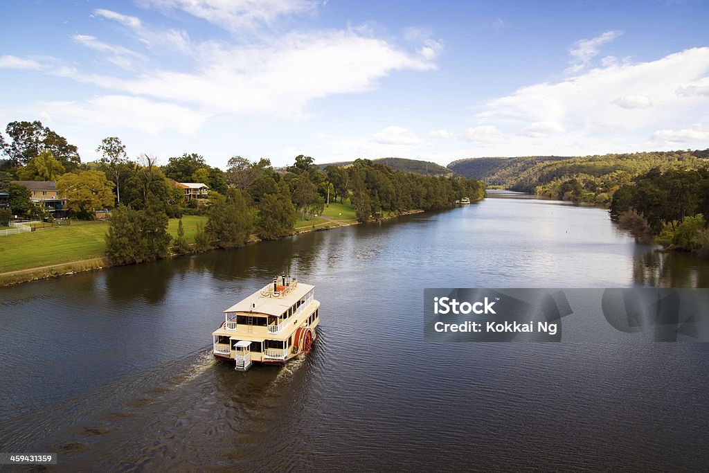 Penrith - Nepean Belle sails down river A classic paddlewheeler makes its way down the Nepean River, passing houses in Penrith along the way. River Stock Photo