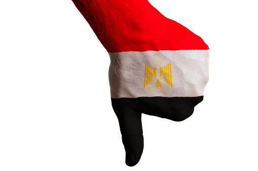 Hand with thumb down gesture in colored egypt national flag as symbol of negative political, cultural, social management of country