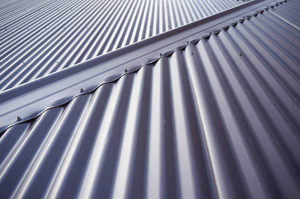 Metal tin roof Metal colourbond roof in blue-gray colour. corrugated iron stock pictures, royalty-free photos & images