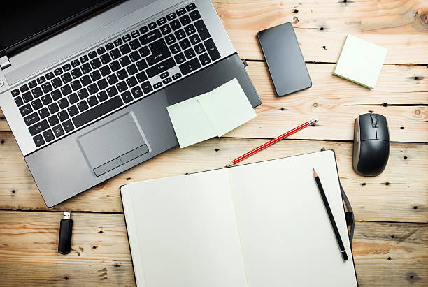 istock Workplace, laptop and notepad on wooden table 459440517