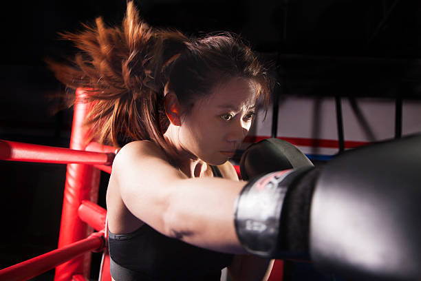 istock Close up of female boxer throwing a punch 459441033