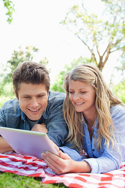 istock Smiling couple enjoying a tablet pc together 459442147