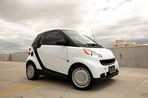 Scottsdale, United States - May 18, 2011: A photo of a parked white Smart Car. The Smart car is a very small and compact car that first debuted in 1998 by Daimler-Benz.