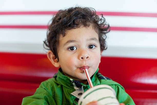 Cute Child Drinking a Milkshake Small boy drinking a delicious chocolate milkshake 2000 photos stock pictures, royalty-free photos & images