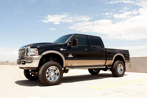 Scottsdale, United States - July 28, 2011: A parked Ford F250 truck, The F250 is a popular truck from Ford, this model happens to have a lift kit, custom wheels and a diesel engine. This model is also known as the King Ranch edition.