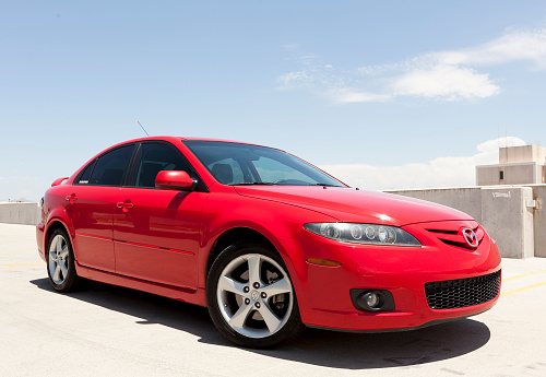 Scottsdale, United States - July 20, 2011: A photo of a parked red 2006 Mazda 6 sedan. The Mazda 6 is a popular sedan in the US, made to compete with such cars as the Honda Accord and Ford Focus.
