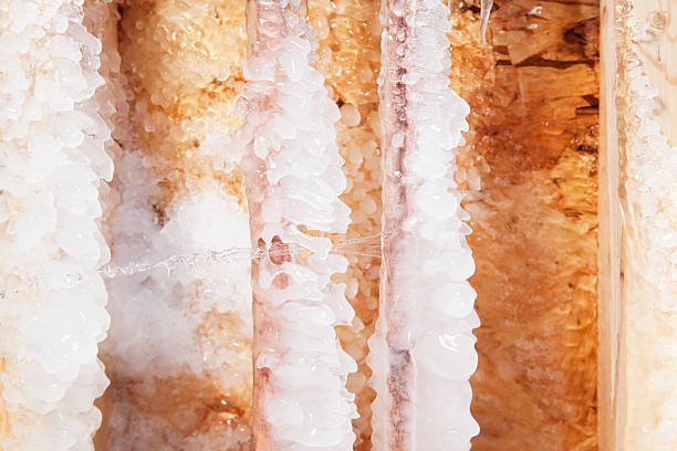 istock Frozen Ice Covered Cracked Copper Water Pipe Leaking 459445983