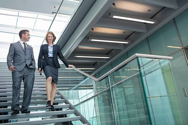 istock Business couple talking in the staircase 459446747