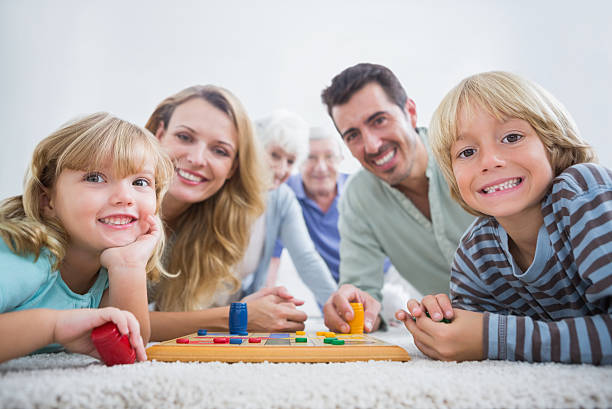 istock Smiling family playing with a board game 459454135