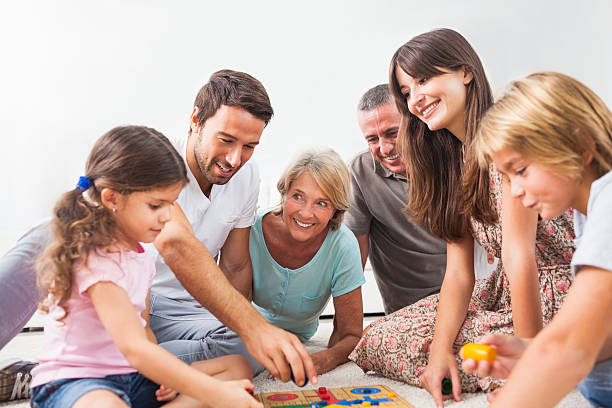 istock Extended family all playing board game 459455003