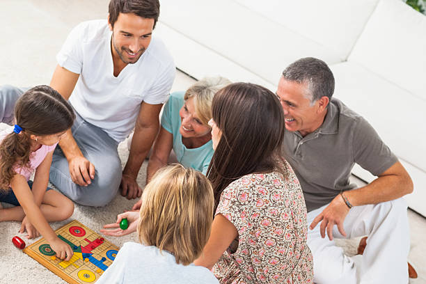 istock Extended family all playing board game on rug 459455005