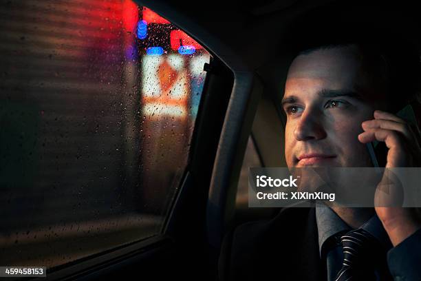 Contemplative Businessman On Phone In Back Seat Of Car Stock Photo - Download Image Now