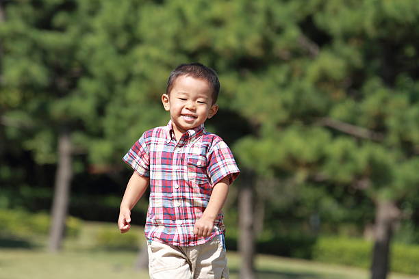 istock Japanese boy running on the grass 459465471