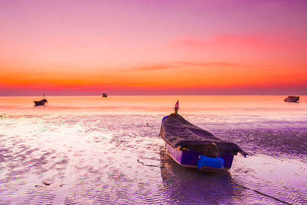 istock boat in the sea under sunset 459468051