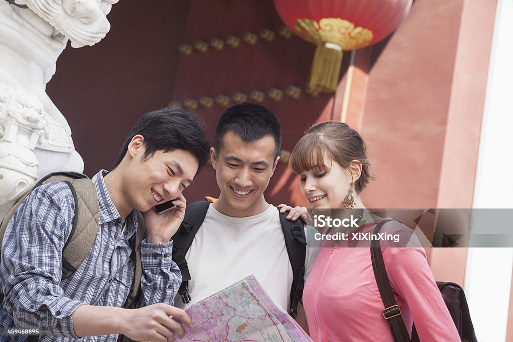 Three people looking at map. Three people looking at map.   China - East Asia Stock Photo