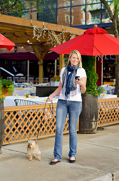 Young Woman Walking with Yorkshire Terrier Dog