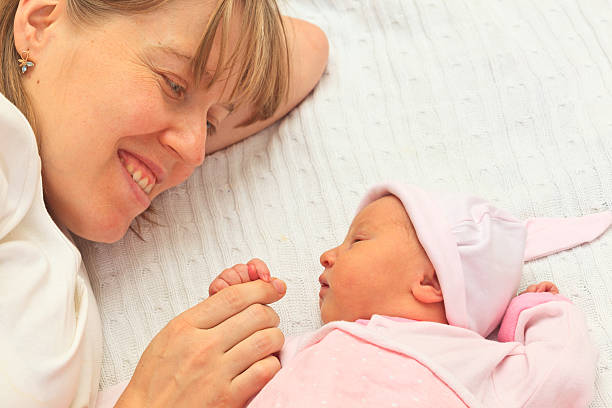 istock mother enjoying time with newborn daughter 459488819