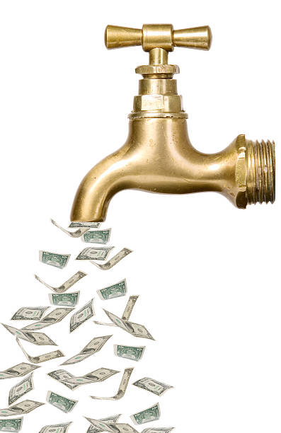 istock Golden vintage tap with money 459502419