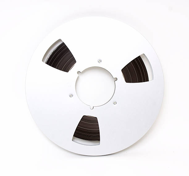 Vintage Tape Reel with Clipping Path Professional 1/4" magnetic tape reel circa 1987. Reel shows tape and splices. reel to reel tape stock pictures, royalty-free photos & images