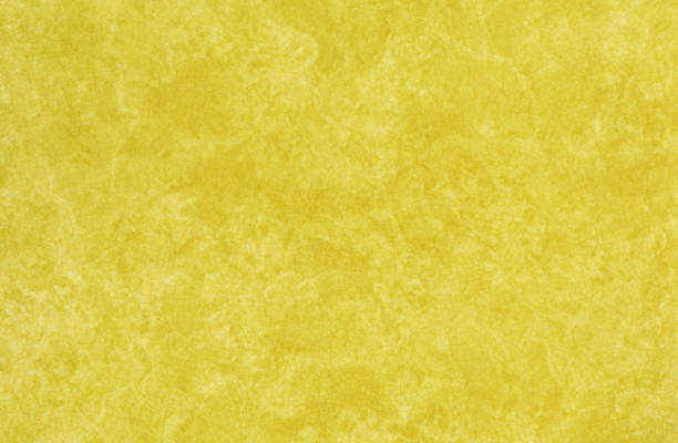 Retro look background image shows a section of harvest gold plastic Formica counter top that was popular in the early Nineteen Seventies in the USA. These laminated plastic countertops were found in homes and diners alike. High resolution scan.