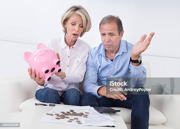 Shocked Couple Holding Piggybank Stock Photo - Download Image Now - Adult, Adults Only, Banking