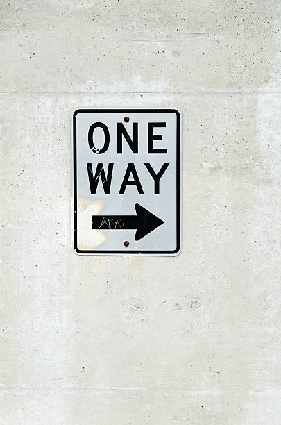 istock One way sign posted on concrete wall 459517987