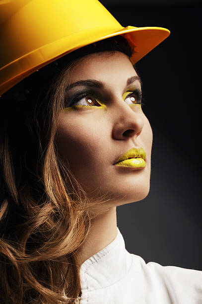 istock Beautiful girl with yellow helmet 459519325
