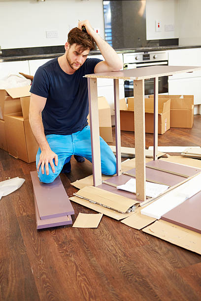 istock Frustrated Man Putting Together Self Assembly Furniture 459521917