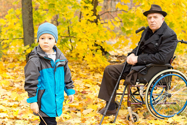 istock Little boy with his handicapped grandfather 459522139