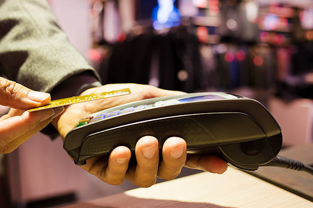 istock Man paying with NFC technology on credit card, clothing store 459551243